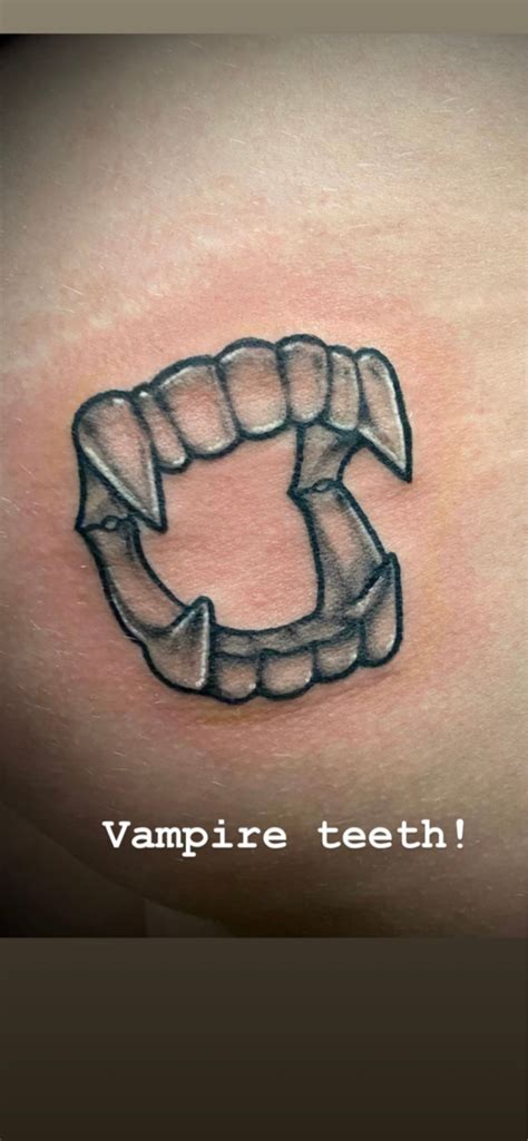 Plastic Vampire Teeth Tattoo