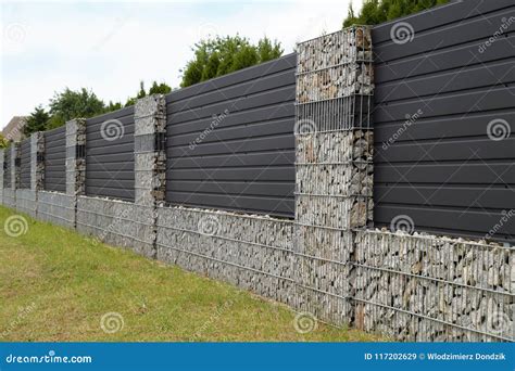 Modern Gabion Fence Wall With Stones In Wire Mesh In The Garden Design ...