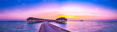 Amazing sunset panorama at Maldives. Luxury resort villas seascape with ...