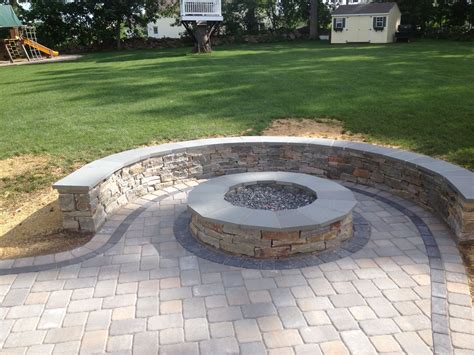 Natural Stone sitting wall with bluestone cap surrounds a fire pit and ...