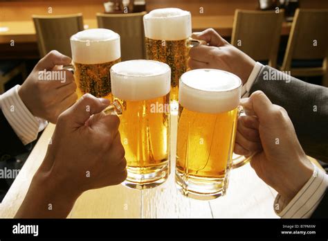 Making a toast with beer Stock Photo - Alamy