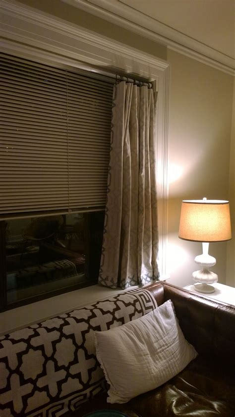 a living room with a couch, lamp and window