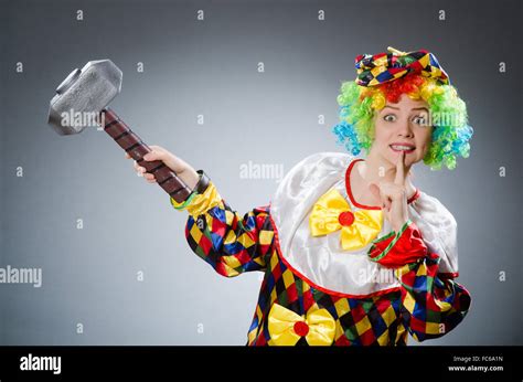 Clown with hammer in funny concept Stock Photo - Alamy