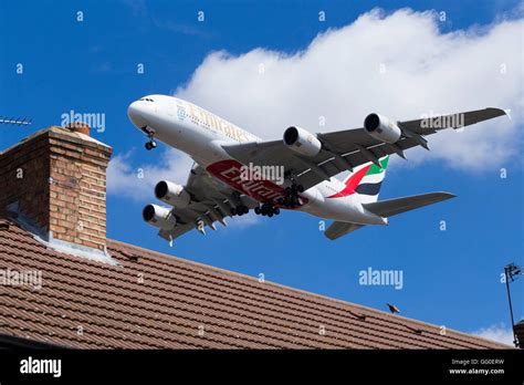 Emirates Airbus / Air Bus A380-861 A6-EEA plane landing over roof tops ...