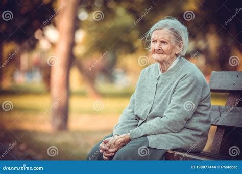 Portrait of Senior Woman Sitting on Bench in Autumn Park. Old Lady ...