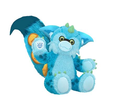 a blue dragon stuffed animal sitting on top of a white background