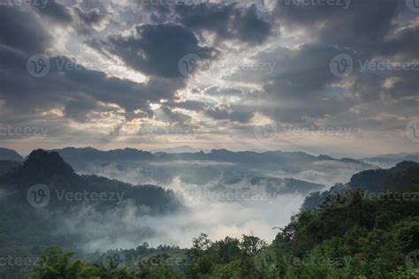 Sunrise through clouds on foggy mountains 2009494 Stock Photo at Vecteezy