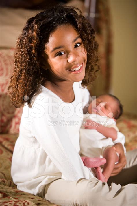 African American Child Holding Tiny Newborn Baby Stock Photos ...