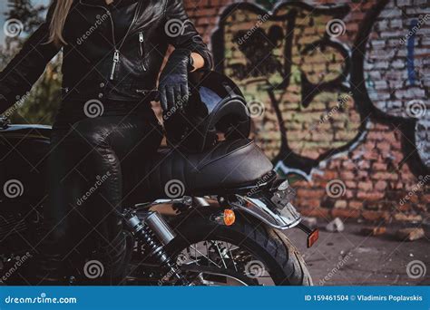 Female Biker in Black with Her Motorbike Next To Graffity Wall Stock ...