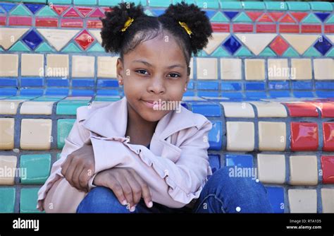 Young black girl closed mouth smile Stock Photo - Alamy