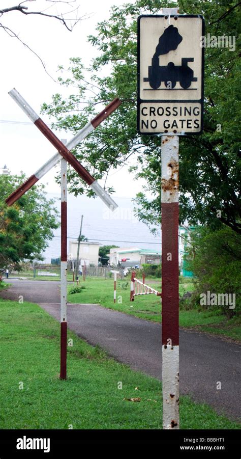 Old fashioned British road sign for railway crossing without gates St ...