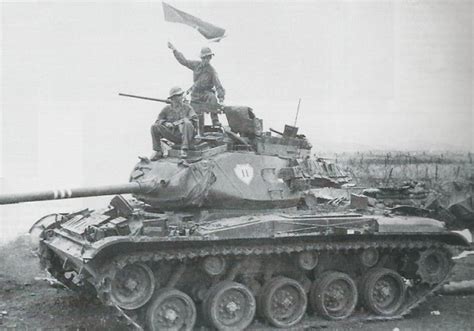 A North Vietnamese soldier waving the flag of the NLF (National ...