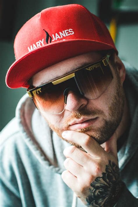 Portrait of a Young Man Wearing a Baseball Cap and Sunglasses · Free ...