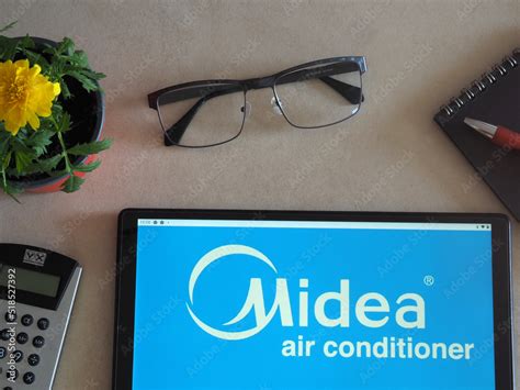 In this photo illustration, Midea Group logo seen displayed on a tablet ...