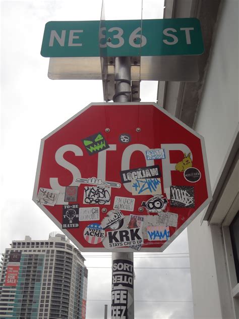 Sticker bombed stop sign across from the Shops at Midtown, in the Miami ...