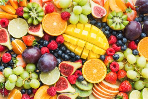 Assortment of healthy raw fruits and berries platter background ...