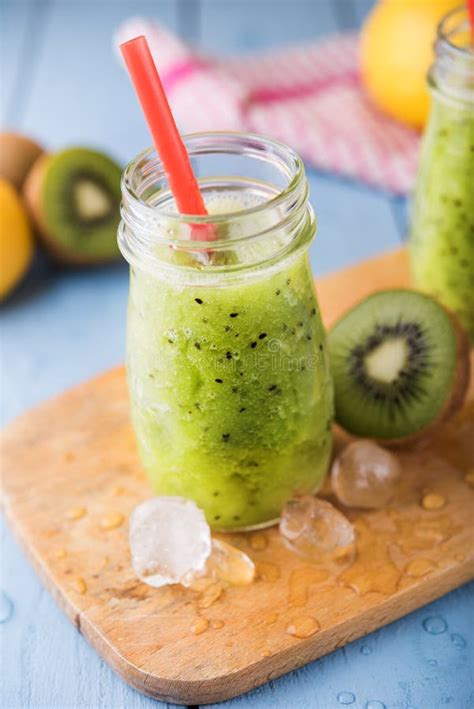 Kiwi Fruit Smoothie On Bright Wooden Background Stock Photo - Image of ...