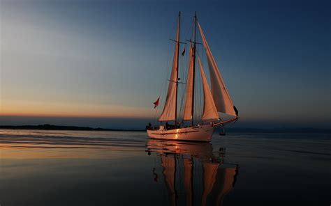 Serene Sailboat at Sunset - HD Wallpaper