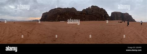 Panoramic view in Wadi Rum at sunrise Stock Photo - Alamy