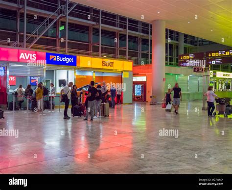 Car rental booths in the arrivals hall at Alicante Airport at night ...