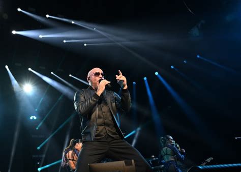 Pitbull’s party anthems and pelvic thrusts keep the rain away from the ...