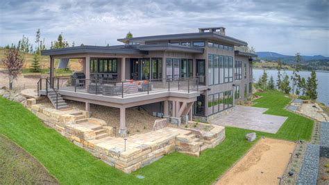 this is an aerial view of a modern house on the water's edge with ...