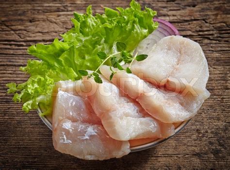 Raw hake fish fillet pieces on dark ... | Stock image | Colourbox