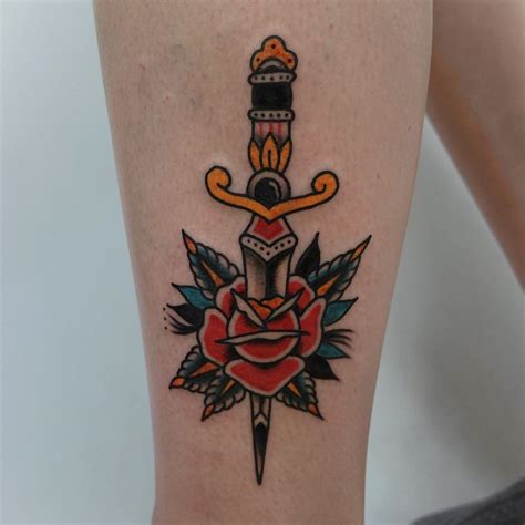 Rose stabbed with a dagger tattoo - Tattoogrid.net