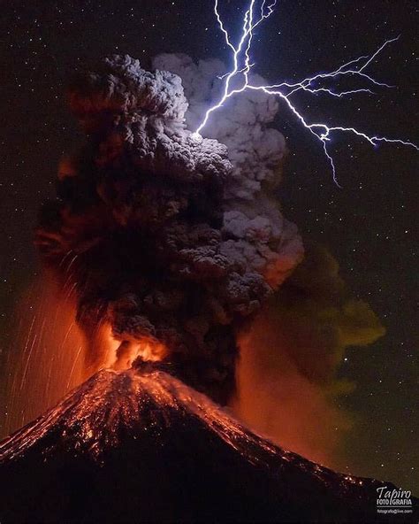 Lighting strikes over an erupting volcano • • • The lightning strike is ...