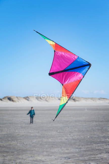 Boy flying kite on beach — child, 12 to 13 years - Stock Photo | #166080566