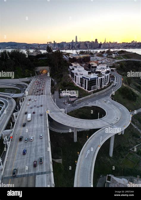 An aerial view of a multiple lane highway road with traffic at sunset ...