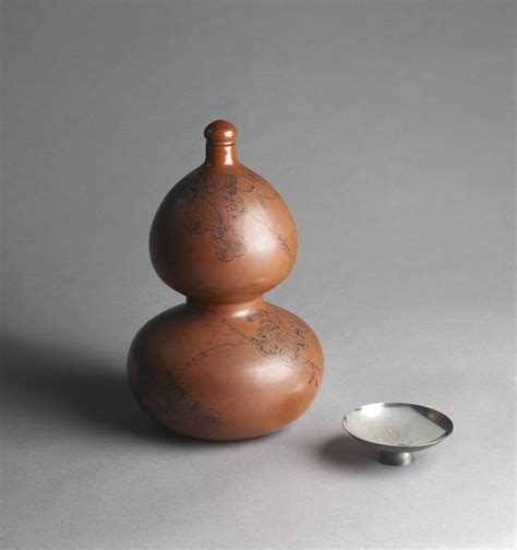 6350 A red lacquer sake bottle and stopper formed as a double gourd ...