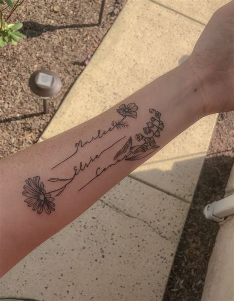 Names with flowers forearm tattoo. Lily of the valley tattoo daisy ...