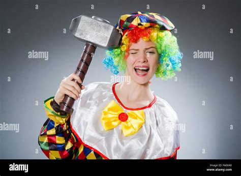 Clown with hammer in funny concept Stock Photo - Alamy