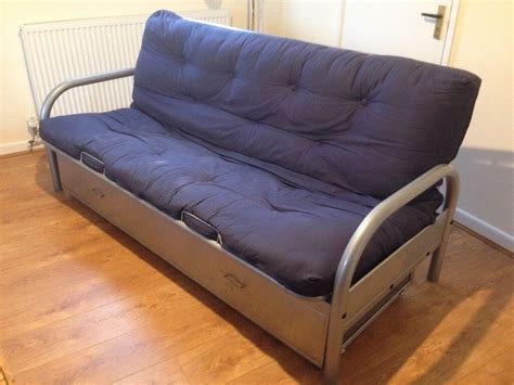 IKEA Three Seater Sofa Bed. Metal Frame, silver. Upholstery, dark blue ...