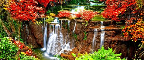 Scenic view of a waterfall in autumn 4K wallpaper download