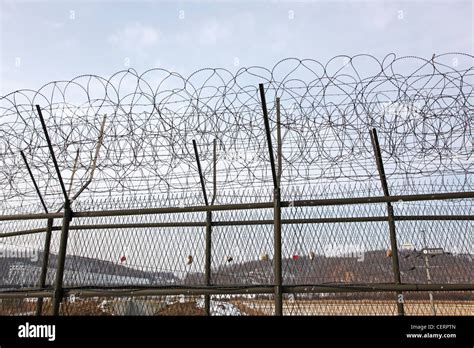 Barbed wire fence and South Korean flag at the DMZ, De-militarised Zone ...