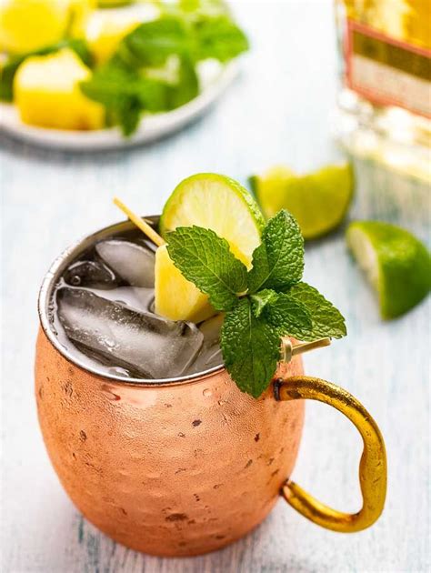 a copper mug filled with ice, lime and mint