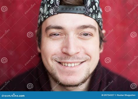 Portrait of Happy Smiling Young Man in a Baseball Cap and Sweater on a ...