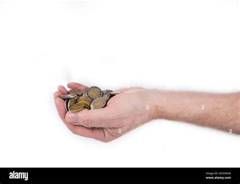 Male hand full of coins on a white background Stock Photo - Alamy