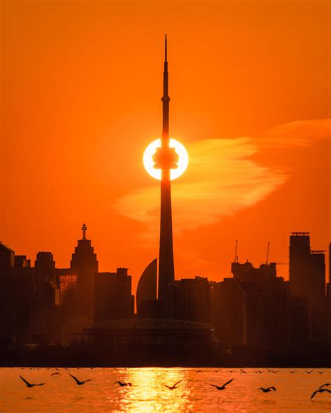 When the Sunrise aligns with the Toronto CN Tower : r/canada