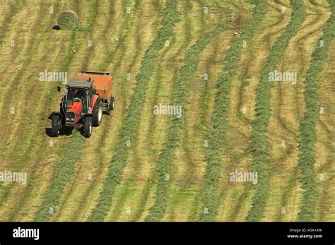 Making big round bales of silage in meadow Stock Photo - Alamy