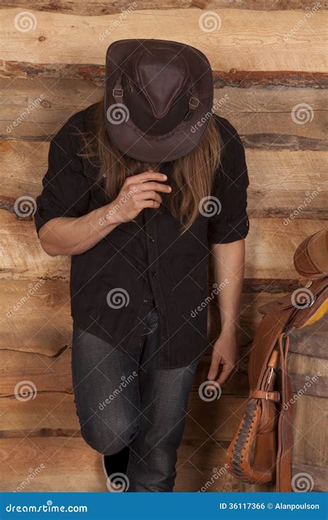 Cowboy with Hat Head Down by Saddle Stock Photo - Image of american ...