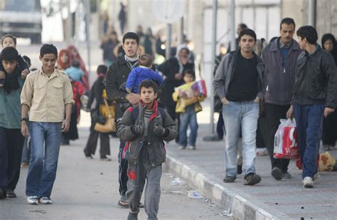 Palestinians in the Rafah refugee camp, in northern Gaza, after an ...