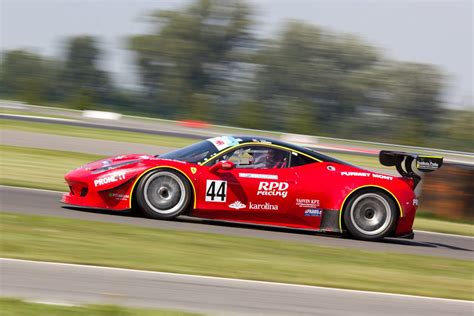 Red Racing Car on Race Track during Daytime · Free Stock Photo