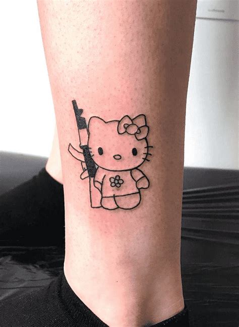 a hello kitty tattoo on the leg of a woman's leg, with a knife in her hand