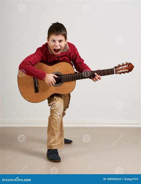 Boy Having Fun with Guitar, Making Music and Singing Stock Photo ...