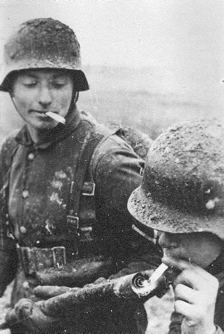 German "Flammenwerfer 35" being used as a lighter by two soldiers ...