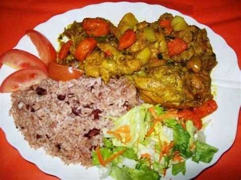 A beautiful plate of Jamaican curry chicken, rice & peas & salad ...