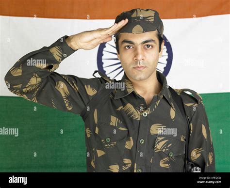 Indian army soldier saluting in front of flag of india in background ...